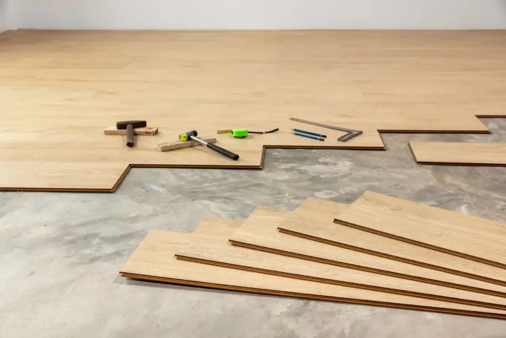Wooden flooring installation with tools laid out.