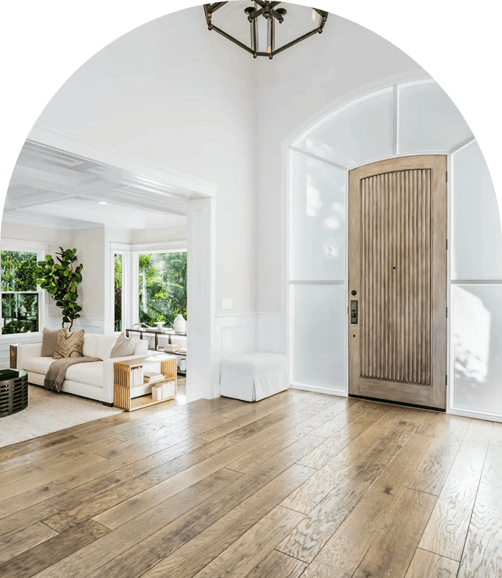 Bright entryway with wooden floor and furniture.