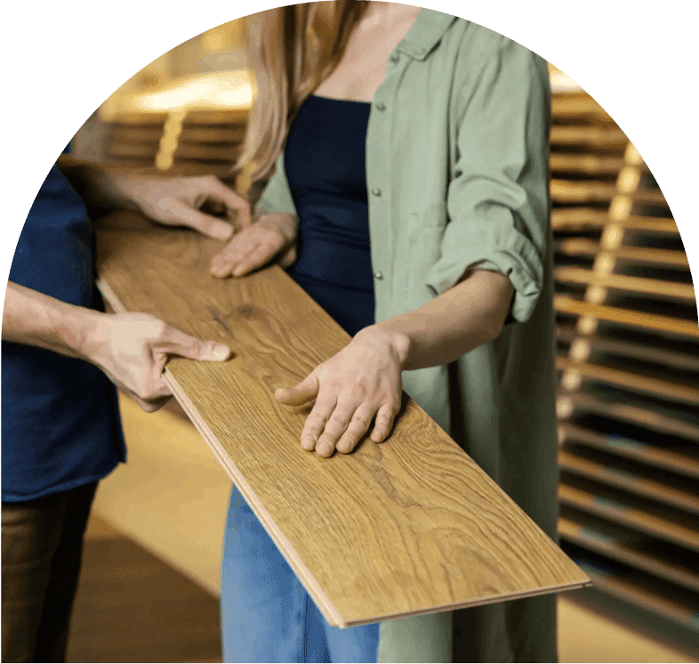 Two people examining a wooden plank.