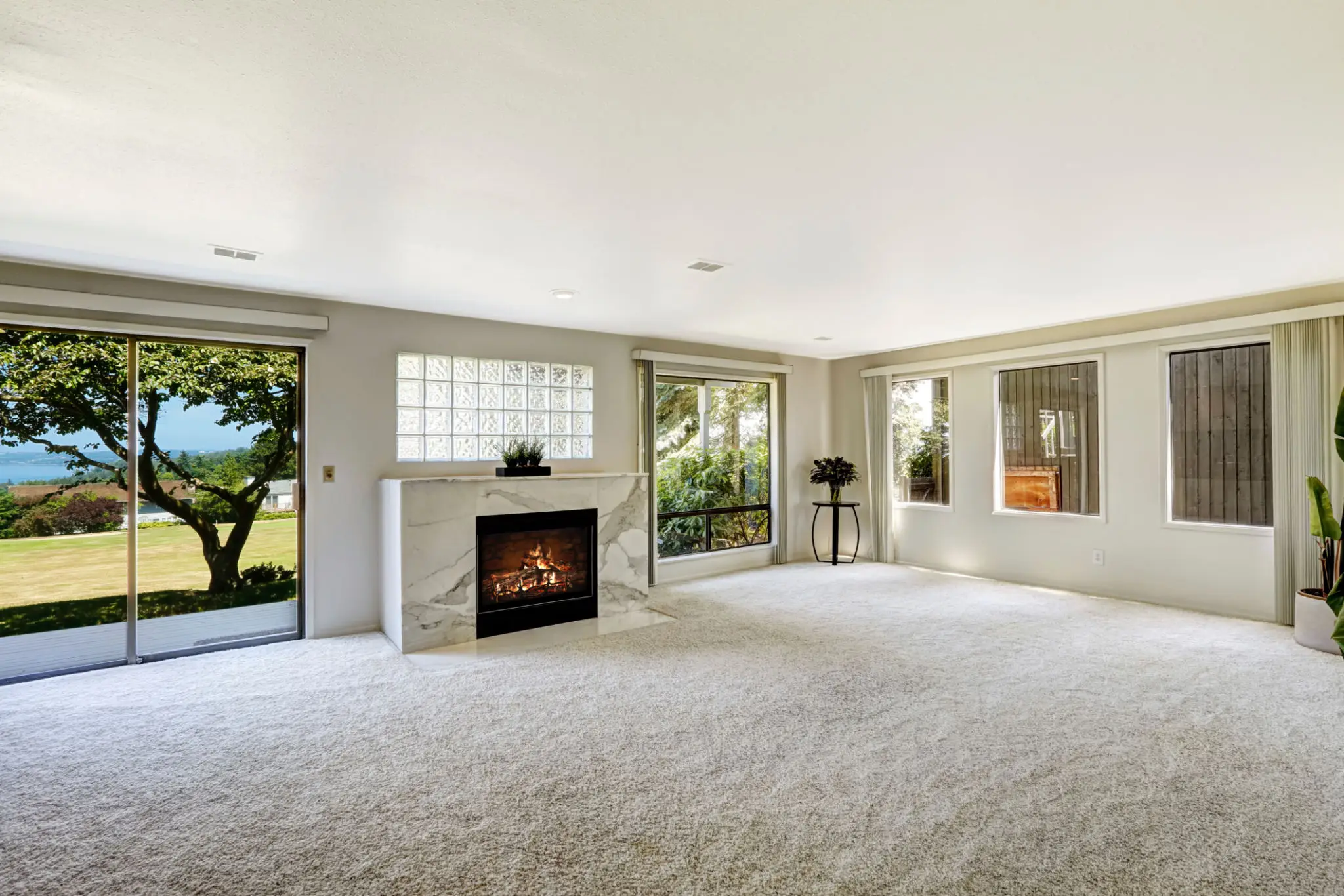 Spacious living room with fireplace and windows.